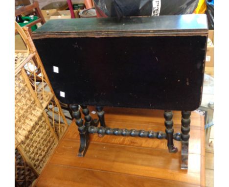 A 54cm ebonised wood Sutherland table, set on bobbin turned supports