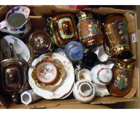 A box containing assorted ceramic items including a set of Staffordshire copper lustre graduated jugs, other copper lustrewar