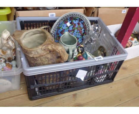 A crate containing a quantity of ceramic and glass items including Royal Doulton, Old Balloon Seller figurine, glass spirit d