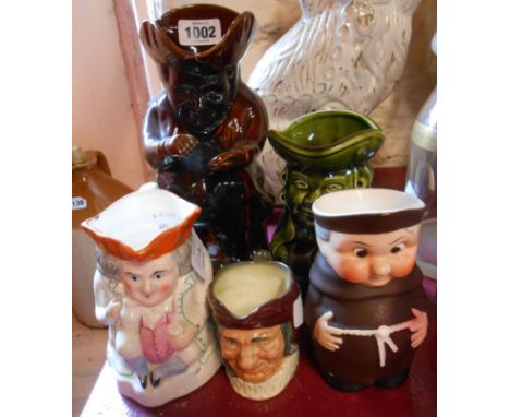 A 19th Century treacle glazed Toby jug, a Staffordshire similar, a Dartmouth green glazed similar - sold with a Goebel monk j
