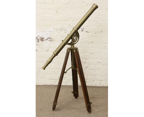 A brass telescope on an adjustable wooden tripod.