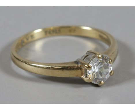 A ladies 9 carat gold ring set with a cubic zirconia and internal inscription 'I Love You', size T.