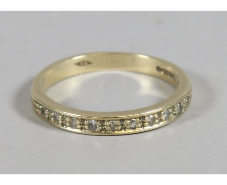 A ladies 9ct gold half eternity ring set with ten diamonds, ring size L.