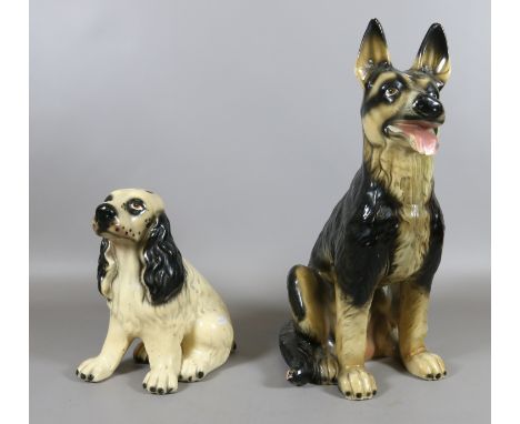 A decorative ceramic model of an Alsatian along with another.