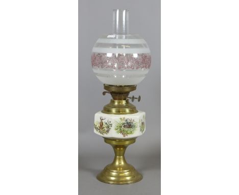 A brass ceramic and glass oil lamp depicting various wildlife scenes.