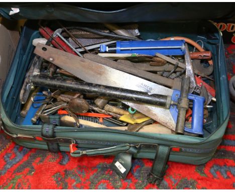 An old suitcase and contents of various tools to include saws, spanners, pumps and files etc.