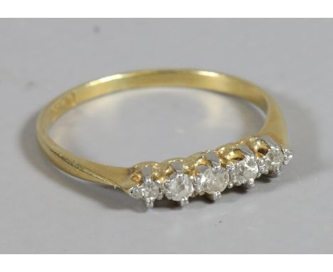 A ladies 18 carat gold five stone diamond ring, size N.