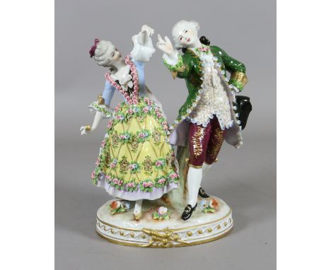 A Sitzendorf figure group formed as a lady and gent dancing in 18th century dress.