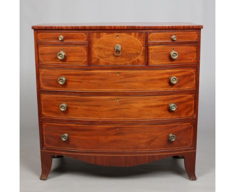 A George IV mahogany bowfront chest of drawers. With strung inlay and raised on splay bracket supports, 124cm wide. Condition