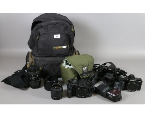 A Kamala camera backpack and contents of SLR photographic equipment including three Minolta Dynax cameras, lenses, filters, f