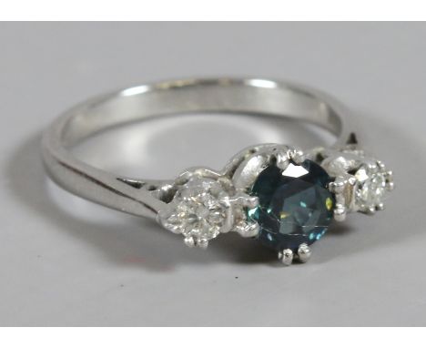 An 18 carat white gold ring set with a sapphire flanked by two diamonds, size N 1/2.