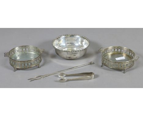 A collection of five silver items to include a bowl with beaded moulding, a pickle fork, sugar nips and two pierced silver an