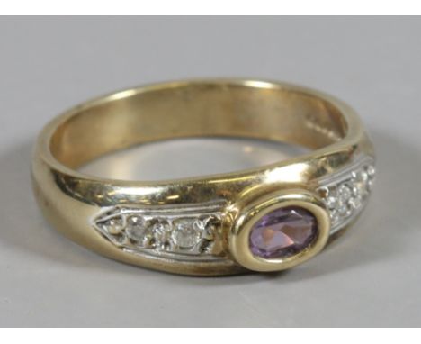 A ladies 9 carat gold ring set with white paste and amethyst stones, size O.
