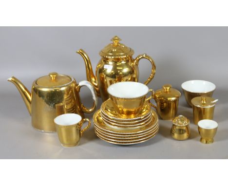 A Royal Worcester part tea service with gilt decoration, approximately sixteen pieces.