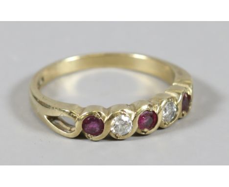 A ladies 9 carat gold ring set with white paste and garnets, size N.