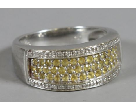 An 18 carat white gold ring set with 40 yellow diamonds.