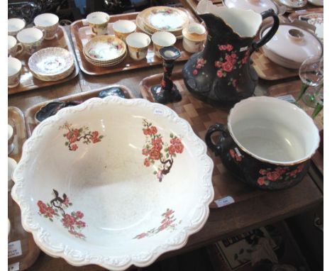 Carlton ware toilet set on a black ground with rose design, comprising: chamber pot; large jug and basin; candlestick; trinke