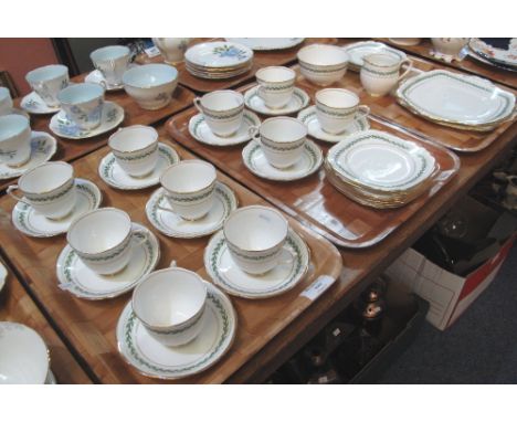 Three trays of Royal Albert Crown china teaware on a white ground with gilt banding and foliate decoration comprising: teacup