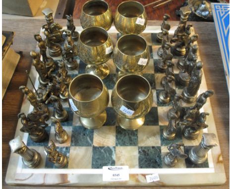 Modern chess set comprising metal Greek figurines on a marble board, together with a set of six brass goblets.(B.P. 24% incl.
