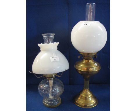 Brass double burner oil lamp with clear funnel and cream shade, together with glass honeycomb design oil lamp with shade. (2)