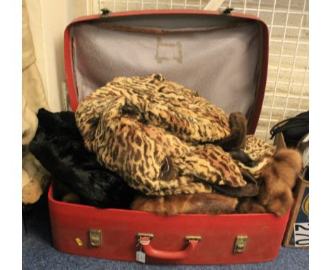 Red vintage suitcase containing various vintage fur items. To include mink fur stole, faux fur leopard print coat, long black