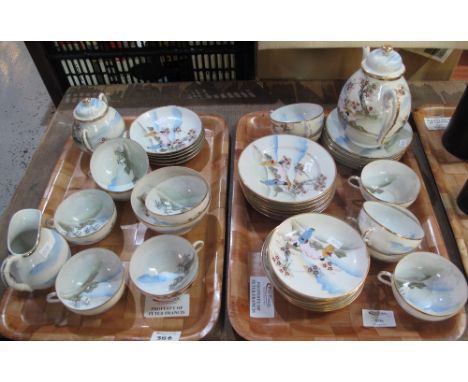 Two trays of Japanese eggshell part teaware comprising: cups and saucers; sucrier; teapot; cream jug; sugar bowl; side plate.