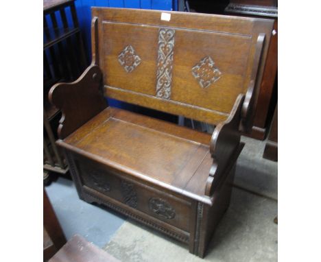 Reproduction carved oak monks bench.(B.P. 24% incl. VAT)