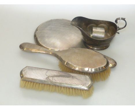 Silver engine turned brush and mirror set, silver sauce boat and napkin ring (5)