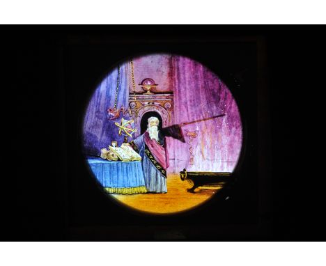 A Wizard hand-painted mahogany-mounted Magic Lantern Dissolve Set, circular, lever-action of wizard in eerie chamber, with mo
