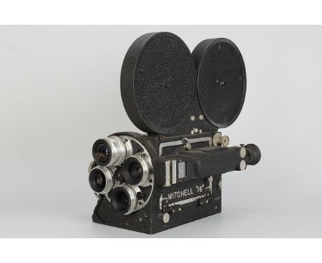 A Mitchell Model 16mm Cine Camera, black, serial no. 651, together with four lenses mounted on rotating turret, body, VG, unt