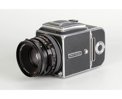 A Hasselblad 500C/M Camera, chrome, serial no. RR1420850, with Carl Zeiss Planar CF T* f/2.8 80mm lens, black, serial no. 713