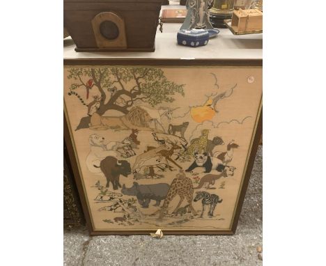 A LARGE TAPESTRY DEPICTING JUNGLE ANIMALS AND FRAMED IN WOOD 