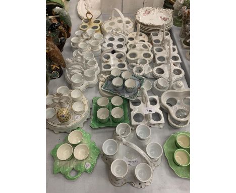 A LARGE COLLECTION OF CERAMIC EGG CUPS AND HOLDERS 