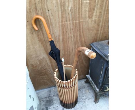 A CERAMIC UMBRELLA/STICK STAND RESEMBLING BAMBOO WITH A WALING STICK AND UMBRELLA 