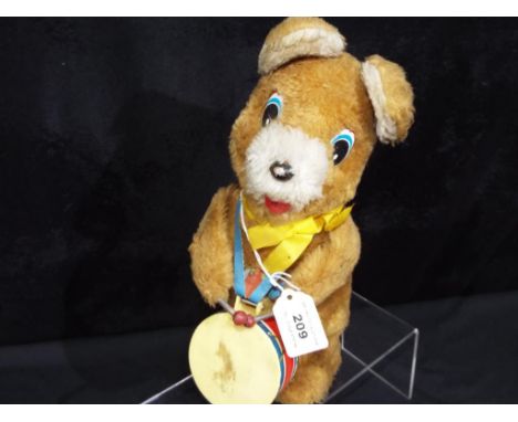 A battery operated mechanical bear playing a drum, marked made in Korea. 