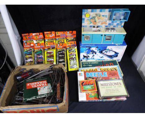 A good mixed lot to include ten five packs of matchbox cars, Hornby clock work O gauge train with some track, a selection of 