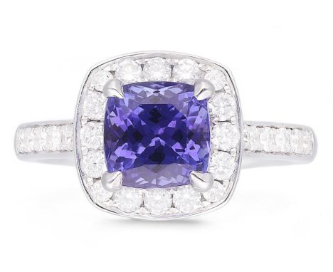 18ct white gold cushion cut tanzanite and round brilliant cut diamond cluster ring, with diamond set shoulders, hallmarked, t