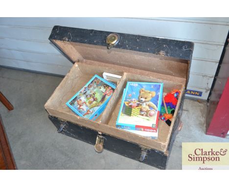 A metal bound travelling trunk and contents of various puzzels