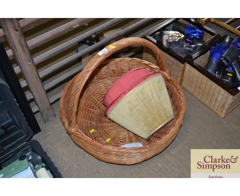 A large wicker log basket and a quantity of lamp shades 