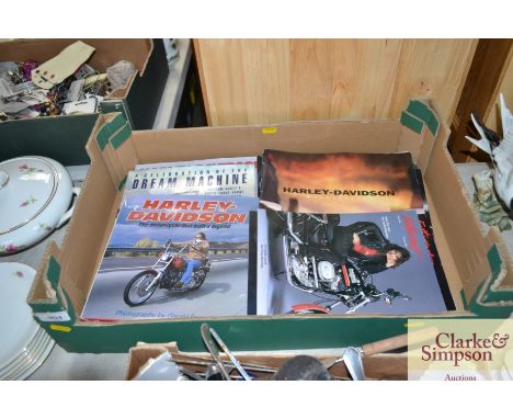 A box of various Harley Davidson books etc.