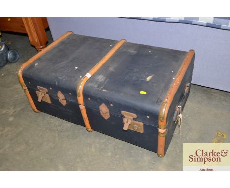 A wooden and brass bound travelling trunk
