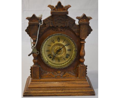 An Ansonia mantle clock with brass coloured dial