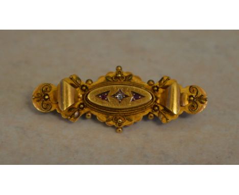 An Edwardian 15ct gold diamond and ruby bar brooch, Chester 1903, total approx weight 4.4g