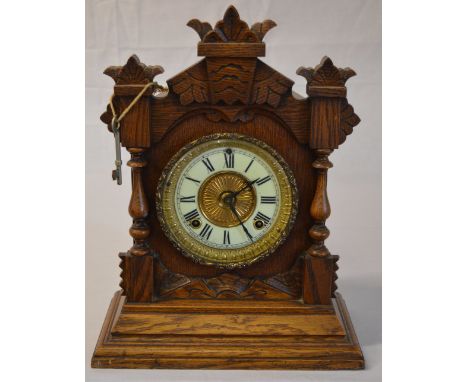 An Ansonia mantle clock with white dial