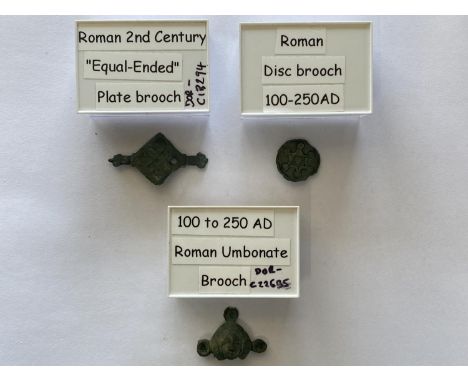THREE ROMAN UMBONATE BROOCHES. A Roman Umbonate Brooch, 2nd-3rd Century A.D. copper-alloy plate brooch with three of four poi
