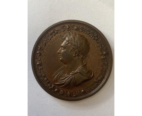 A GEORGE IV BRONZE CORONATION MEDAL. The obverse with laureate bust l. within a border of roses, thistles and shamrocks 'Geor