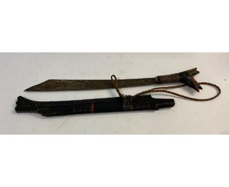 A BORNEO DYACK 'HEAD HUNTERS' SWORD AND SCABBARD. A sword with a 44cm shaped pointed blade with sharpened edge, stamped HKB, 