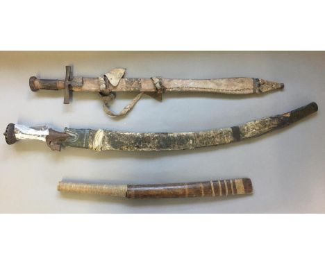 A TULWAR TYPE SWORD AND SCABBARD AND TWO OTHERS. A 19th century Indian Tulwar sword with a 71cm curved blade with double side