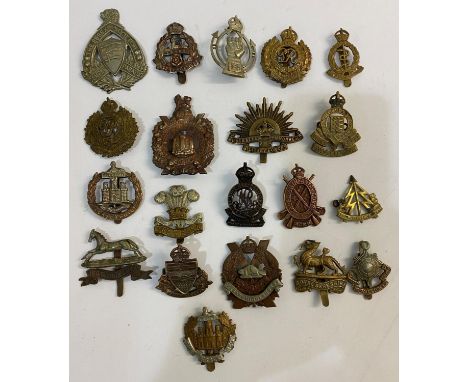 A COLLECTION OF CAP BADGES, FIRST WORLD WAR AND LATER. A collection of cap badges to include badges for the Surrey Yeomanry, 