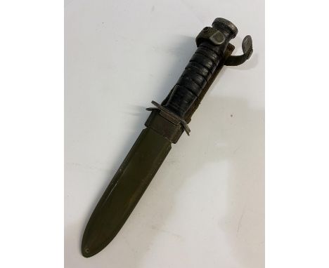 A US M3 FIGHTING KNIFE AND SCABBARD BY UTICA. With a 17cm pointed blade with double sided point, the cross guard marked 'US M